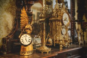 Old,Vintage,Antique,Bronze,Clock,And,Utensil,On,Wooden,Shelf,