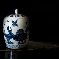 Antique,Chinese,Porcelain,Jar,In,An,Auction,Against,A,Black